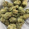 Grapes and Cream THCa Flower buds on a white background, showcasing dense, purple-hued nugs with a sweet, fruity aroma